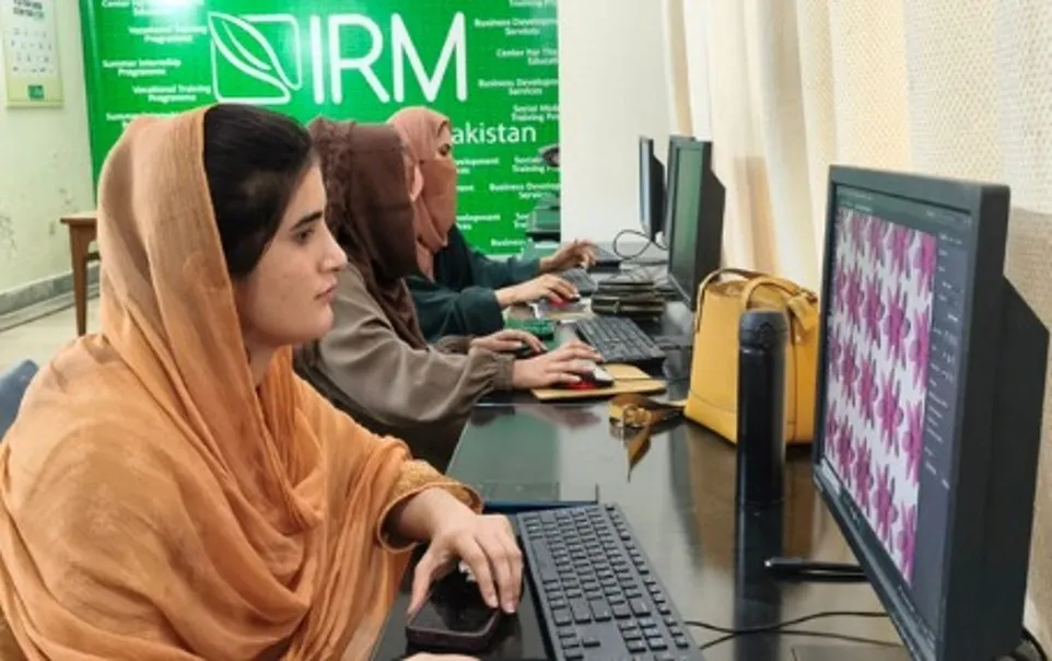 Women trainees at computers in the IRM Tech training lab
