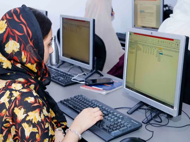 Smart STEP trainee typing at a computer workstation